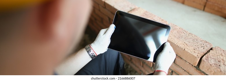 Construction Worker Holding Tablet With Black Turned Off Screen