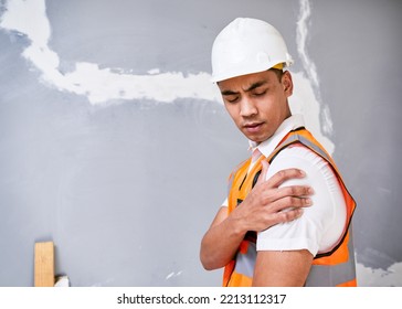 Construction Worker Holds Shoulder In Pain From Workplace Injury On Site