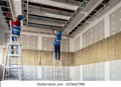 Construction worker installation ceiling