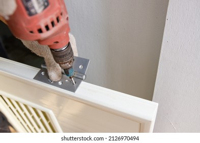 Construction Worker Installing A Bathroom Door