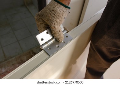 Construction Worker Installing A Bathroom Door