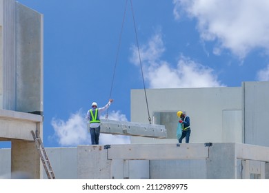 Construction Worker Are Installing The Precast Concrete Beam At Housing Estate, Build A House, Worker Wearing Safety Uniform, Safety Helmet And Color Vest.