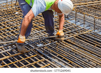 Construction Worker Installing Rebar For Reinforce Concrete Formwork At Construction Site.