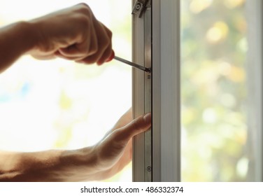 Construction Worker Installing Window In House