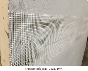 Construction Worker Insulating House Facade With Mineral Rockwool. External Wall Insulation System Mineral Wool For Energy Saving.