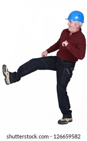 Construction worker kicking something