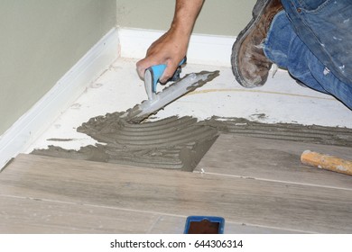 Construction worker laying new tile