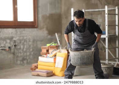 Construction worker lifting carricot in a house under reform - Powered by Shutterstock