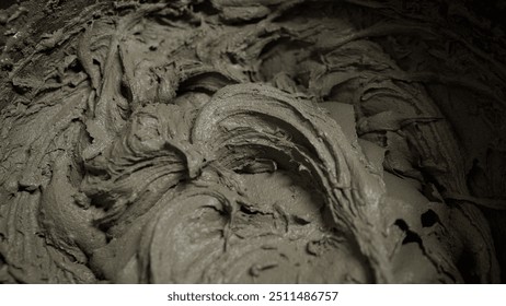 Construction worker mixes tile adhesive or cement in a bucket with a mixing drill, preparing materials for renovation projects - Powered by Shutterstock