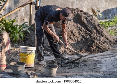 A Construction Worker Mixing Cement And Sand Under The Hot Sun. Tegal, Central Java, Indonesia 27 June 2021