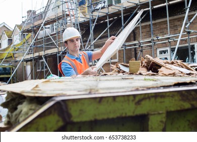 Construction Worker On Building Site Putting Waste Into Rubbish Skip