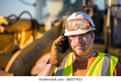 Construction Worker On Cell Phone Looking Down