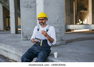 Construction Worker On Lunch Break On Construction Site