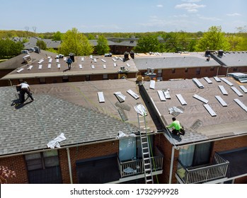 Construction Worker On A Renovation Roof The House Installed New Shingles