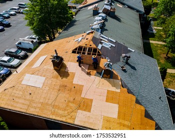 Construction worker on a renovation roof the house installed new shingles - Shutterstock ID 1753532951