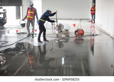 Construction Worker Painting Epoxy Flooring Or Floor Hardener