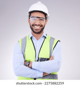 Construction worker in portrait, man with crossed arms and smile, architect or engineer in building industry on studio background. Happy contractor, professional builder with helmet and goggles - Powered by Shutterstock