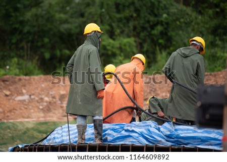 Construction worker pouring a concrete at mass foundation