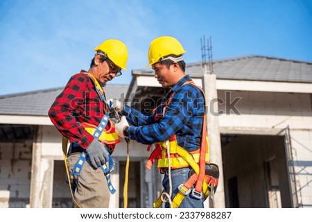 Construction worker preparing safety in work clothes Before installing new roofing tools Roofing tools, electric drills and used on new wooden roofs with metal sheets