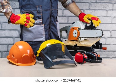 Construction Worker With Protective Equpment Against Brick Wall.