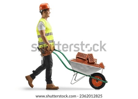 Construction worker pushing a wheelbarrow with bricks isolated on white background