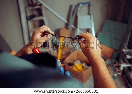 
Construction Worker Putting on Protective Glasses for Work. Specialist using  personal protective equipment on worksite