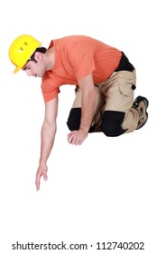 Construction Worker Reaching Down To Empty Copyspace