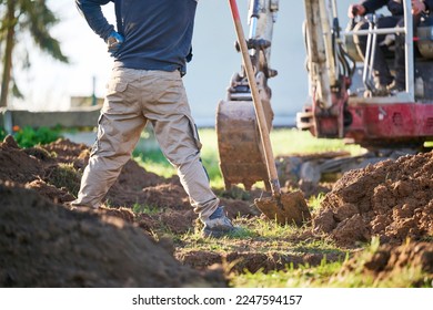 Construction worker in construction site.
Construction worker standing and watching bucket digger digging trench. - Shutterstock ID 2247594157