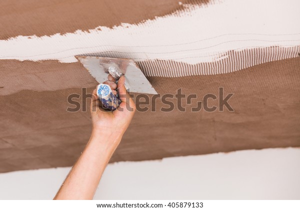 Construction Worker Skim Coating Ceiling After Stock Photo