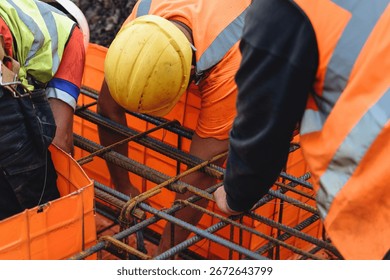 Construction worker steel fixer assembling rebar at building site