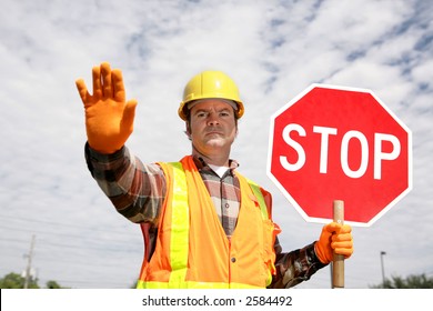 A Construction Worker Stopping Traffic, Holding A Stop Sign.