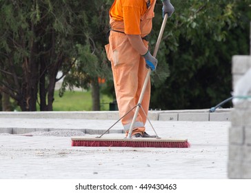 Construction worker sweeping on the building site - Powered by Shutterstock