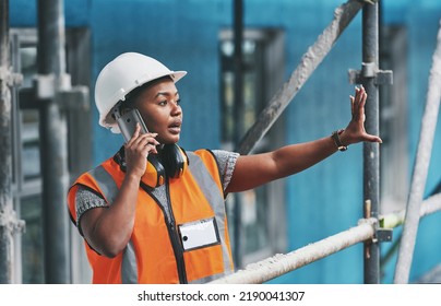 Construction Worker Talking On A Phone Call While Standing In An Empty Building. Professional Builder Discussing Plans And Strategy, Checking The Inside Structure. Civil Engineer Doing A Safety