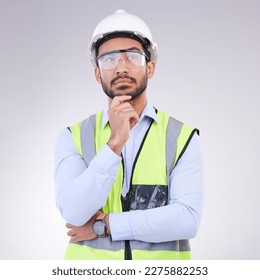 Construction worker thinking, serious man with ideas and architect or engineer in building industry on studio background. Male contractor, mockup and professional builder with helmet and goggles - Powered by Shutterstock