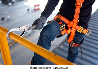 Construction worker use safety harness and safety line working on a new construction site project. - Shutterstock ID 1109366228