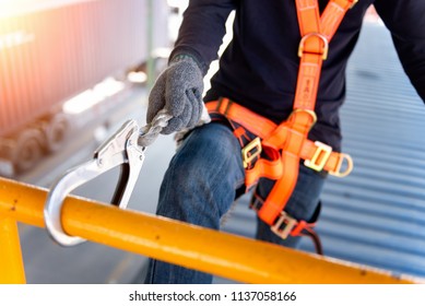 Construction worker use safety harness and safety line working on a new construction site project.Harness is a equipment for safety in construction site.