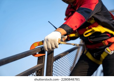 Construction worker use safety harness and safety line working on a new construction site project. - Powered by Shutterstock