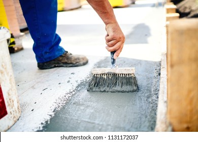 Construction Worker Using Brush And Primer For Hydroisolating And Waterproofing House