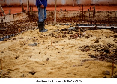 Construction worker is using compacted soil compactor.