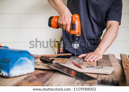 Construction Worker Using Drill To wood.
