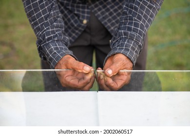 a construction worker is using glass cutting tools