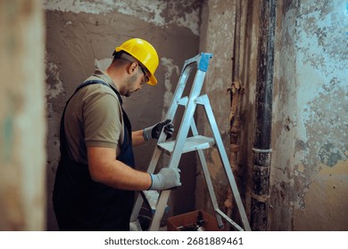 
Construction Worker Using a Ladder on the Work Site 
Contractor complies with safety regulations at work
