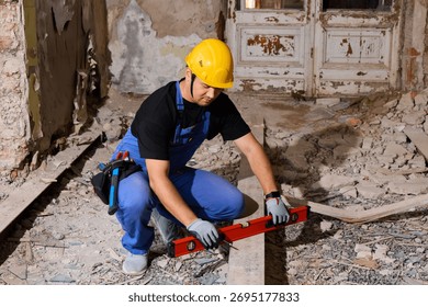 Construction worker using a level tool in a dusty room