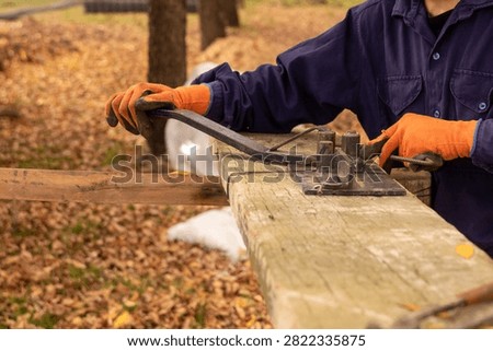 Construction worker using manual rebar bender to shape steel stirrups for concrete reinforcement