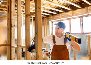 A Construction Worker Using Power Tool in Unfinished Basement of New Home