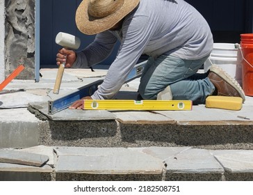 Construction Worker Using A Rubber Mallet