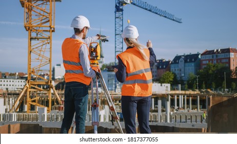 Construction Worker Using Theodolite Surveying Optical Instrument for Measuring Angles in Horizontal and Vertical Planes on Construction Site. Engineer and Architect Using Tablet Next to Surveyor.