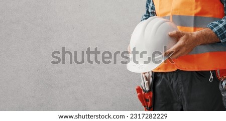 Construction worker wearing personal protective equipment: safety at work concept, banner with copy space