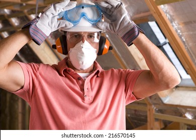 Construction Worker Wearing Protective Mask In Attic