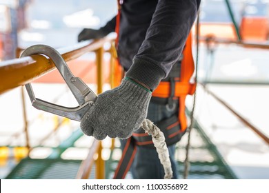 Construction worker wearing safety harness and safety line working on construction - Shutterstock ID 1100356892